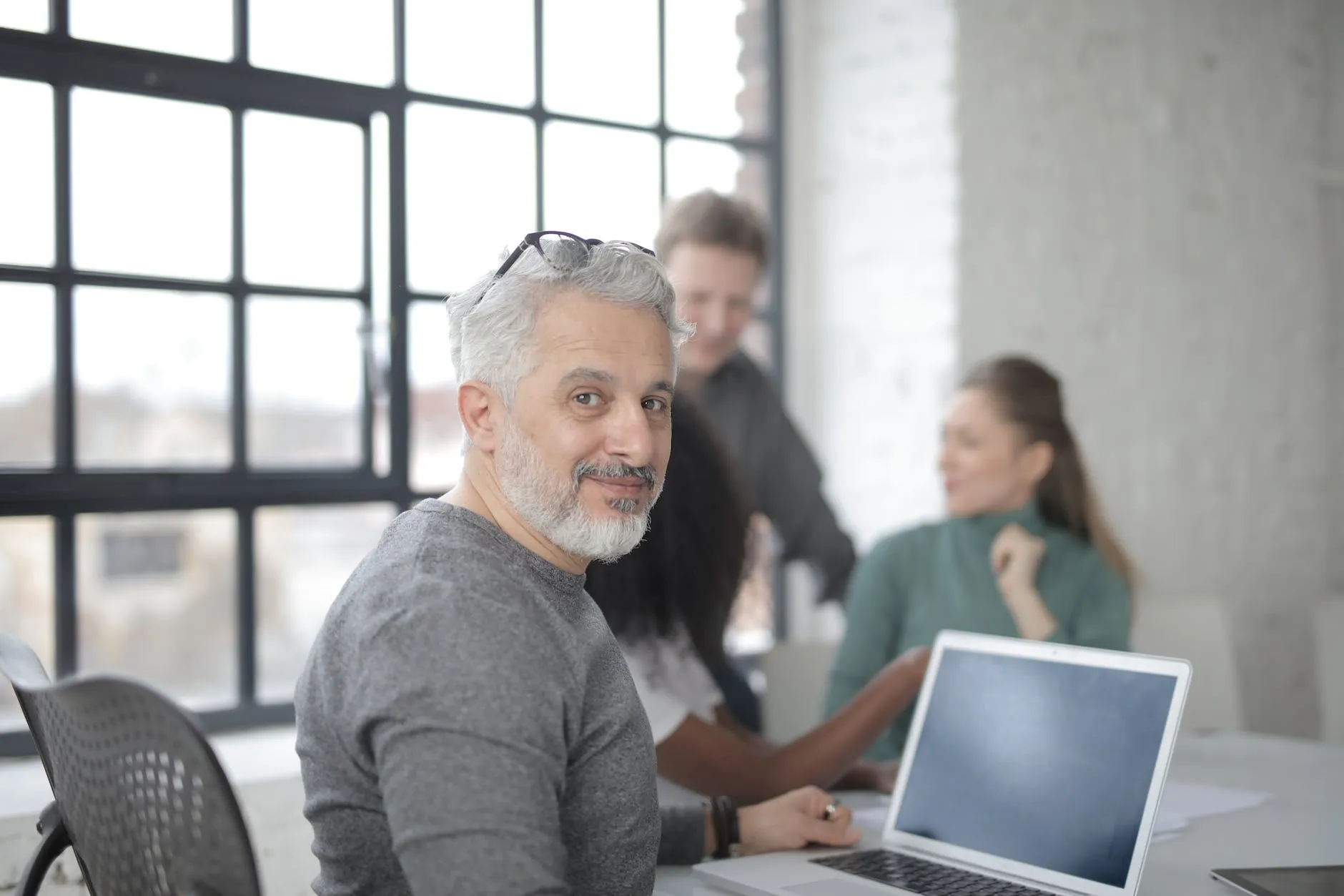 A man sitting in front of a laptop computer.