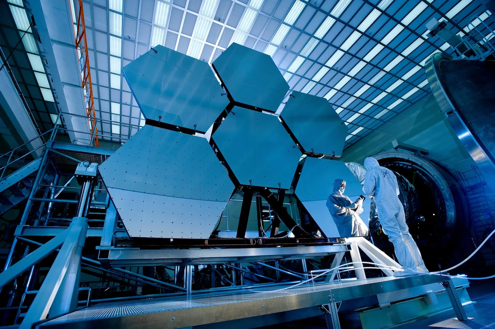 A man working on a large object in a building.